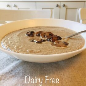 Mushroom soup in a white bowl with a spoon.