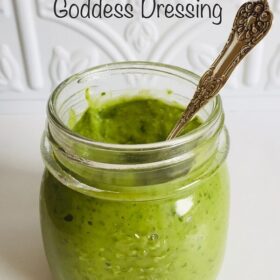 Some green salad dressing in a glass mason jar.