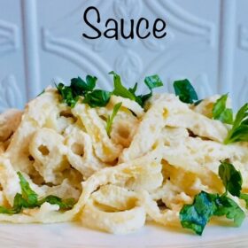 A white plate with a generous portion of pasta.