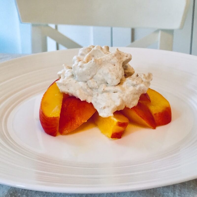 A dollop of sugar-free whipped cream on top of some peaches.