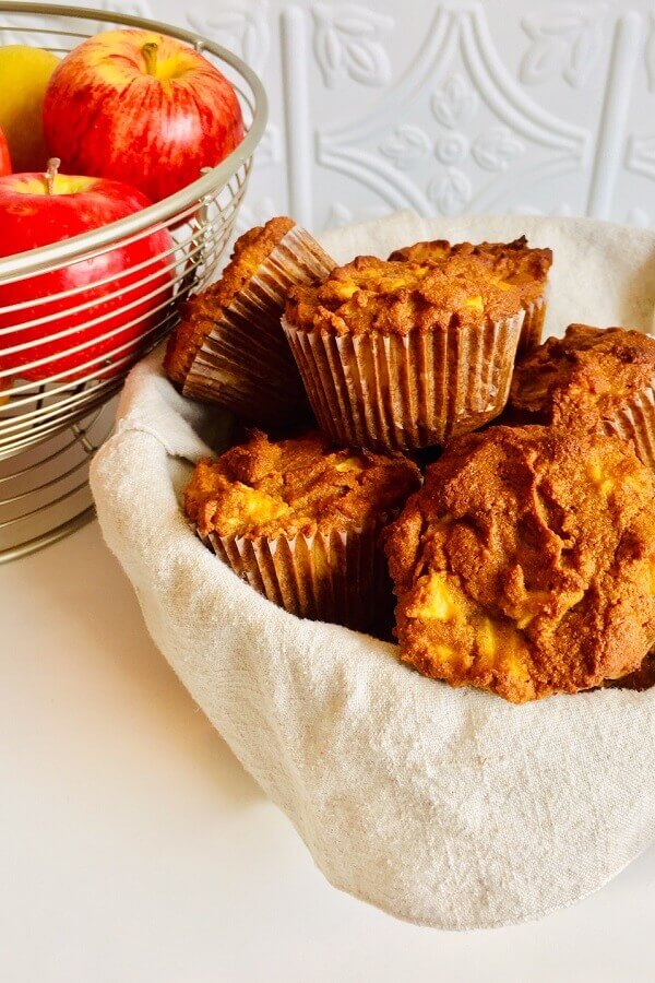 paleo apple muffins in a basket with a linen napkin.
