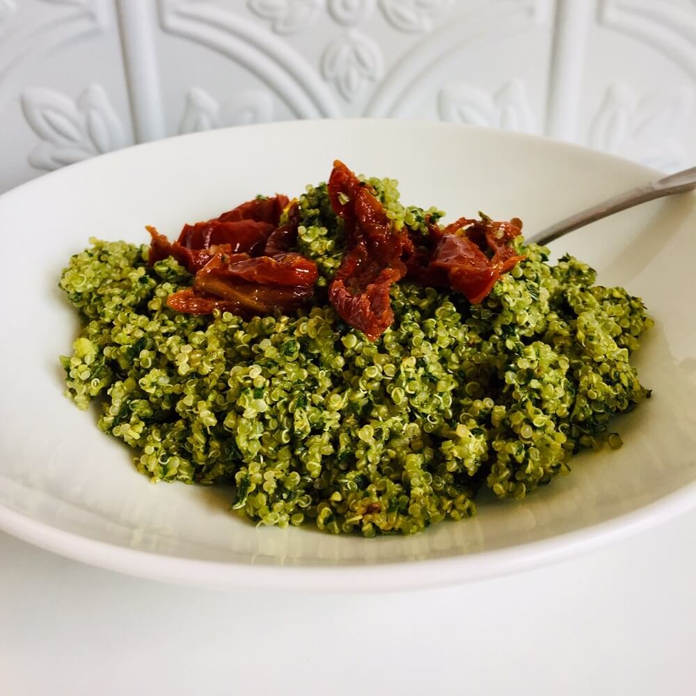 Pesto quinoa with sun-dried tomatoes on top.