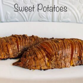 Hasselback sweet potatoes on a white plate.