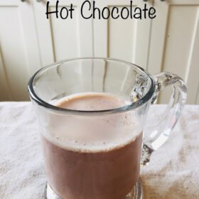Hot chocolate in a glass mug.