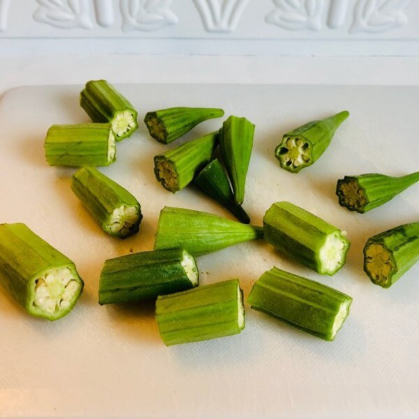 Sliced okra on a cutting board.