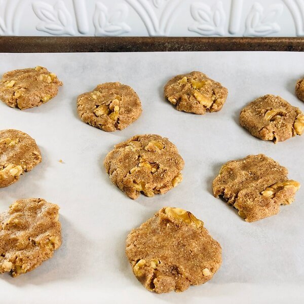 Flattened raw cookie dough on a tray.