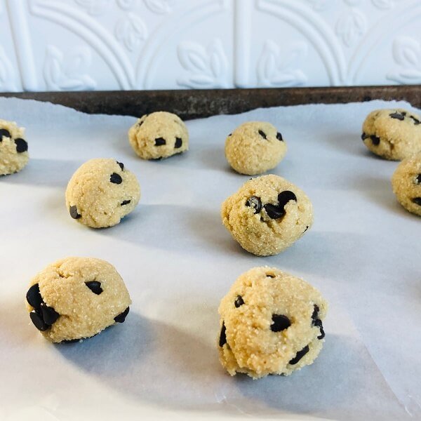 Paleo cookie dough balls on a sheet pan.