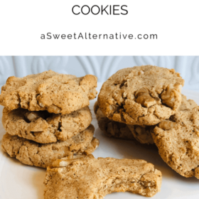 A pile of cookies against a white tile background.