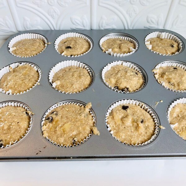 A muffin tray filled with raw batter.