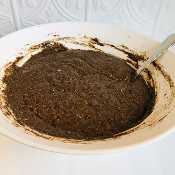 A white bowl filled with thick brown batter.