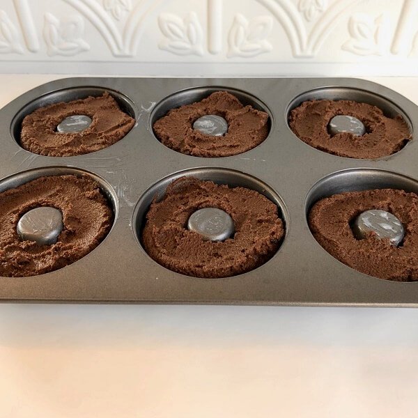 Raw batter in a donut pan.