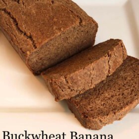 A loaf of banana bread with two slices cut.