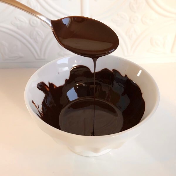 Melted chocolate dripping off a spoon.