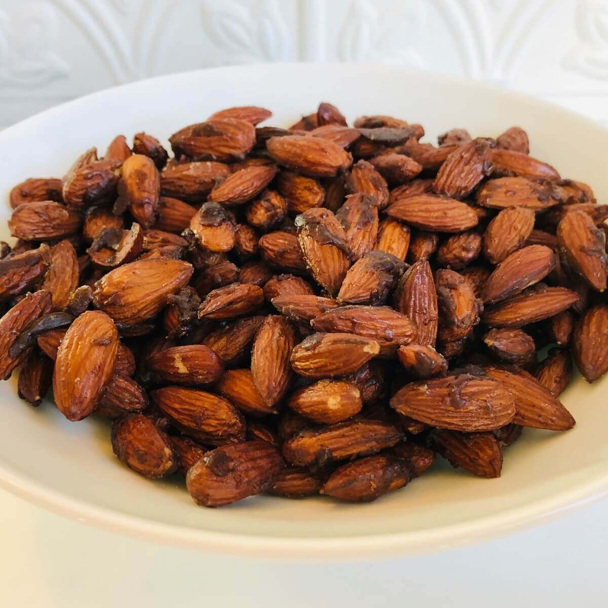 A bowl of vegan candied almonds.