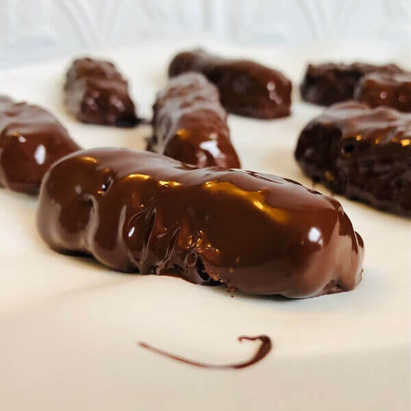 Chocolate covered coconut bars on a plate.
