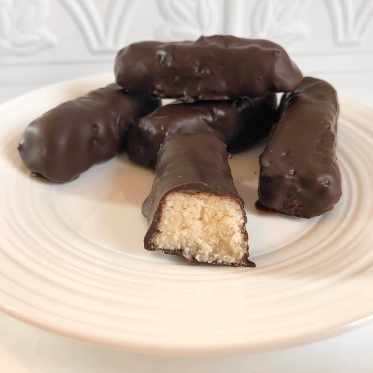 Coconut candy bars displayed on a plate.