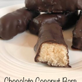 coconut chocolate candy bars displayed on a white plate.