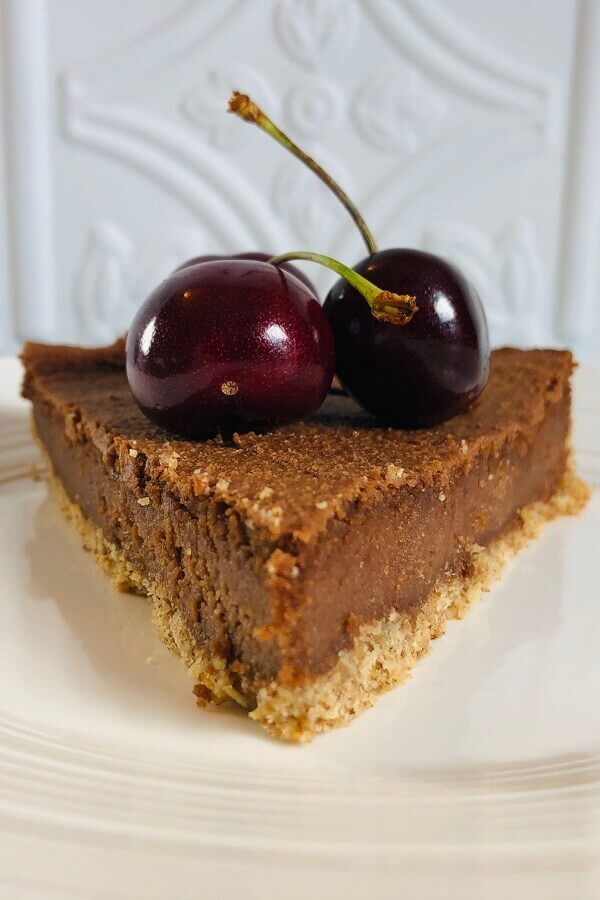 A slice of cheesecake on a white plate.