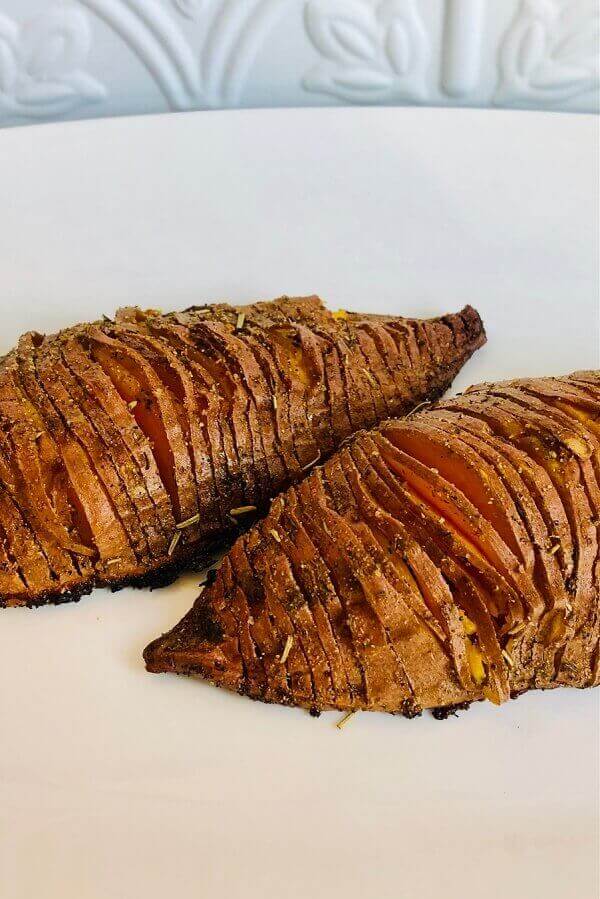 Hasselback potatoes on a white plate.