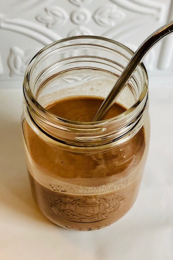 A chocolate smoothie in a glass jar.