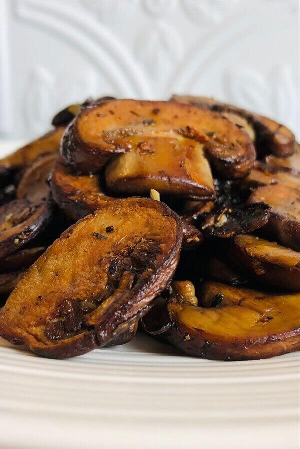 Sauteed mushrooms on a white plate.