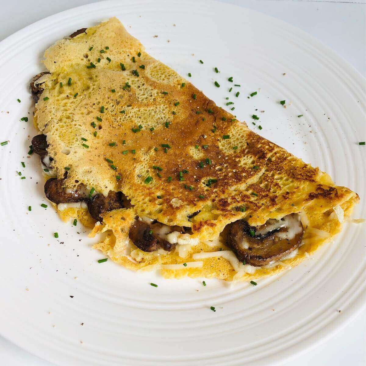 A chickpea flour omelette on a white plate.