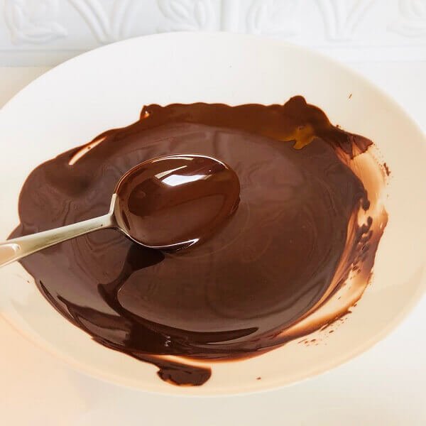 Melted chocolate in a white bowl.