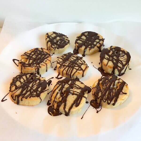 Cookies drizzled with chocolate on top.