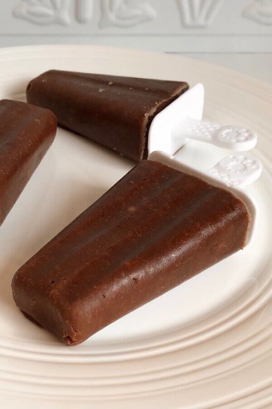 Chocolate popsicles displayed on a plate.