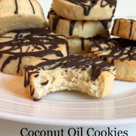 8 cookies on a plate with a bite missing from one.