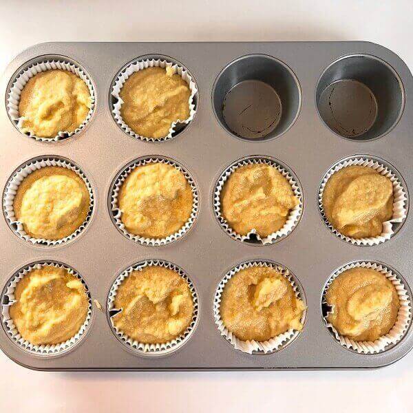 Raw corn muffin batter in a pan.