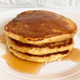 Gluten free oat flour pancakes stacked on a plate.
