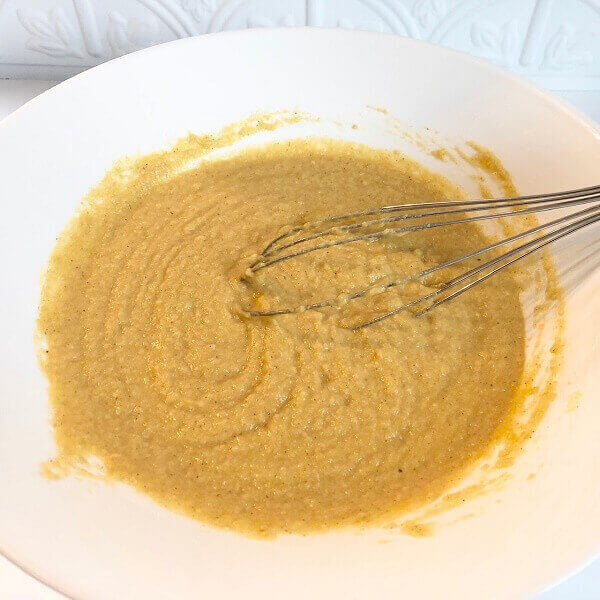 Muffin batter in a large white mixing bowl.