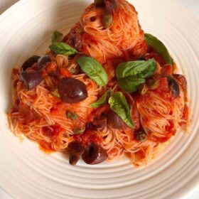 A big portion of pasta on a white plate.