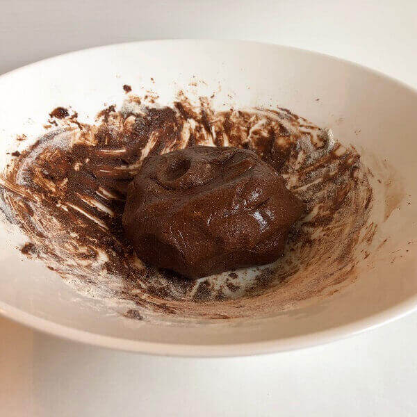 Cookie dough in a large white mixing bowl.