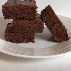 Brownies arranged on a white plate.