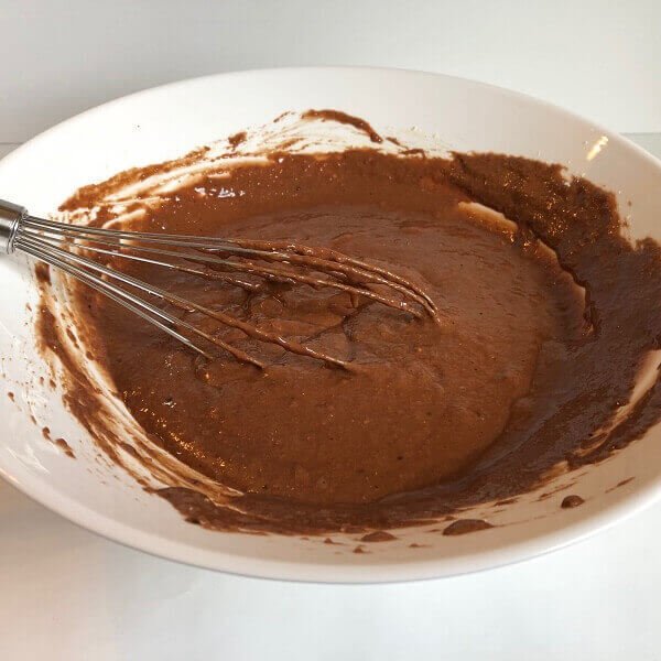 A large mixing bowl filled with raw cake batter.