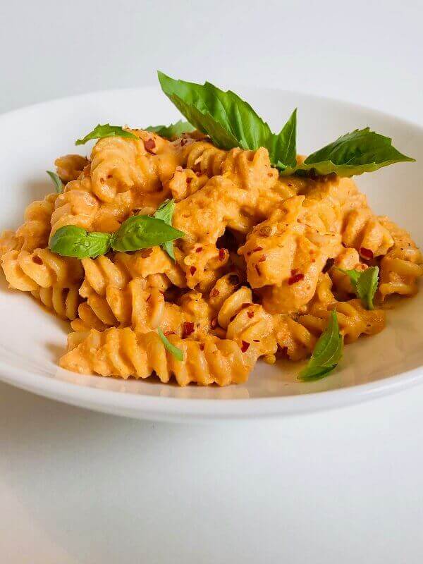 Creamy tomato pasta in a bowl.