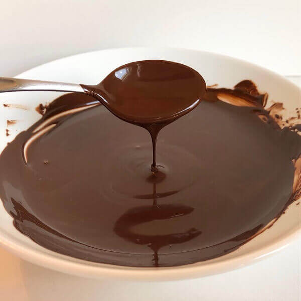 Melted dark chocolate in a bowl.