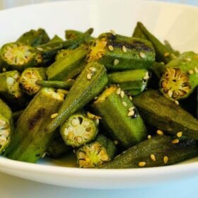 Roasted okra in a white bowl.