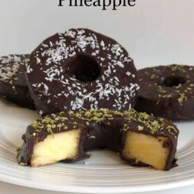 Chocolate pineapple rings displayed on a white plate.