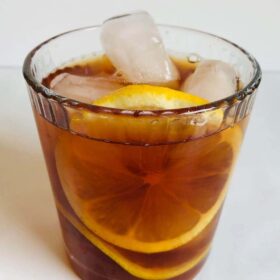 Iced tea in a glass with lemon.