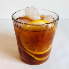 Sweet tea in a glass with lemon and ice.