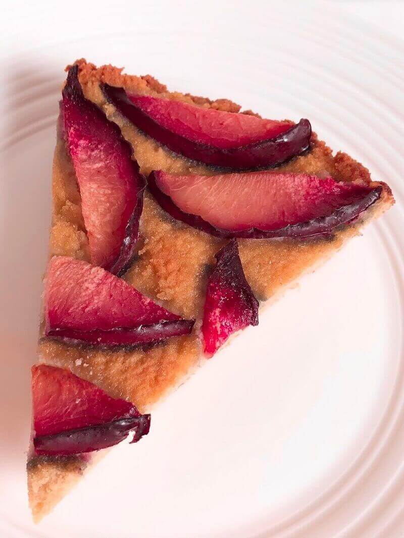 A slice of cake on a white china plate.