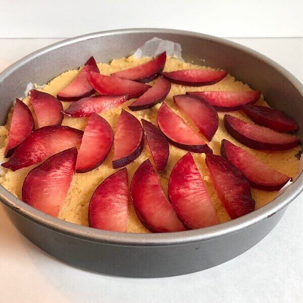 Raw cake batter in a round pan.