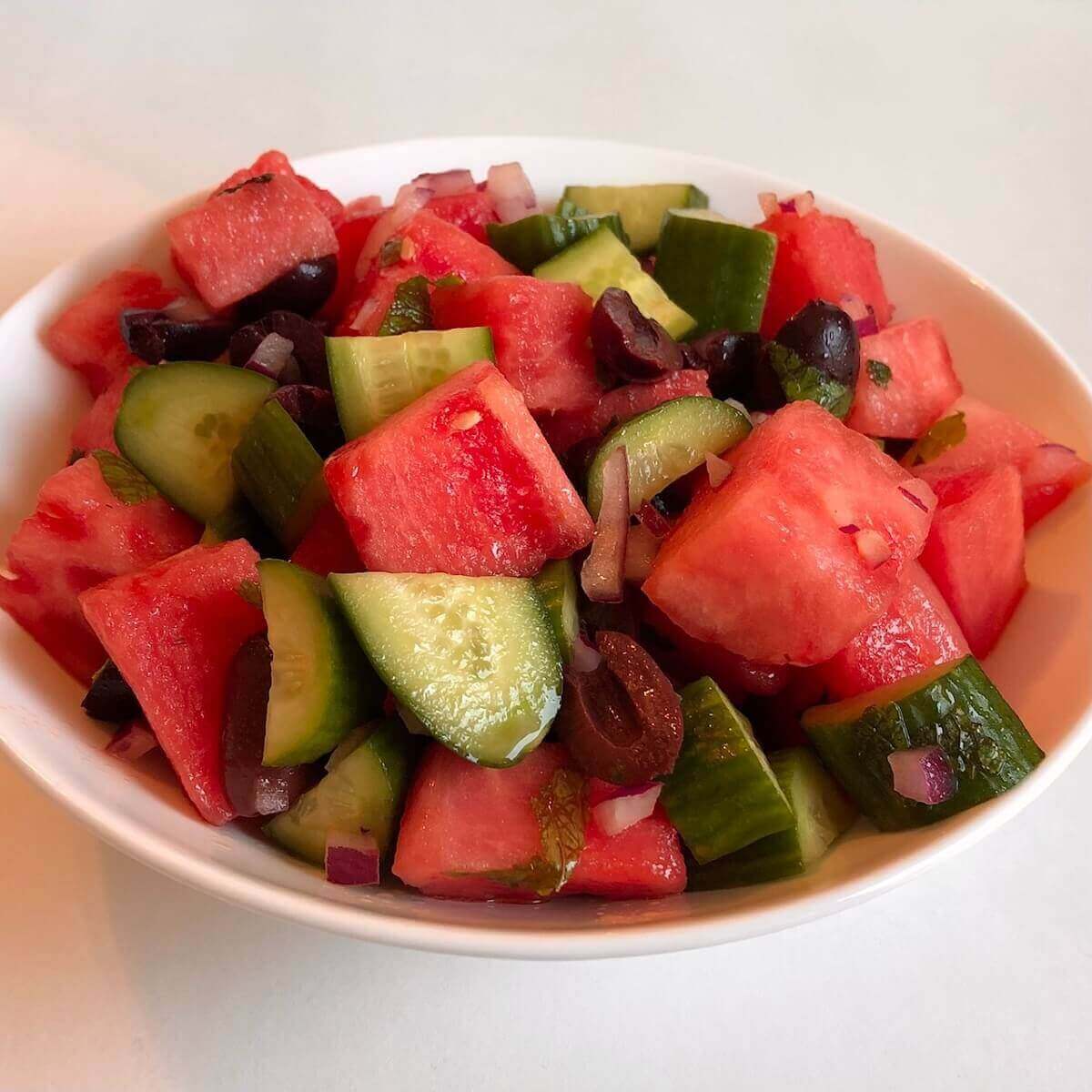 Vegan watermelon salad in a ceramic bowl.