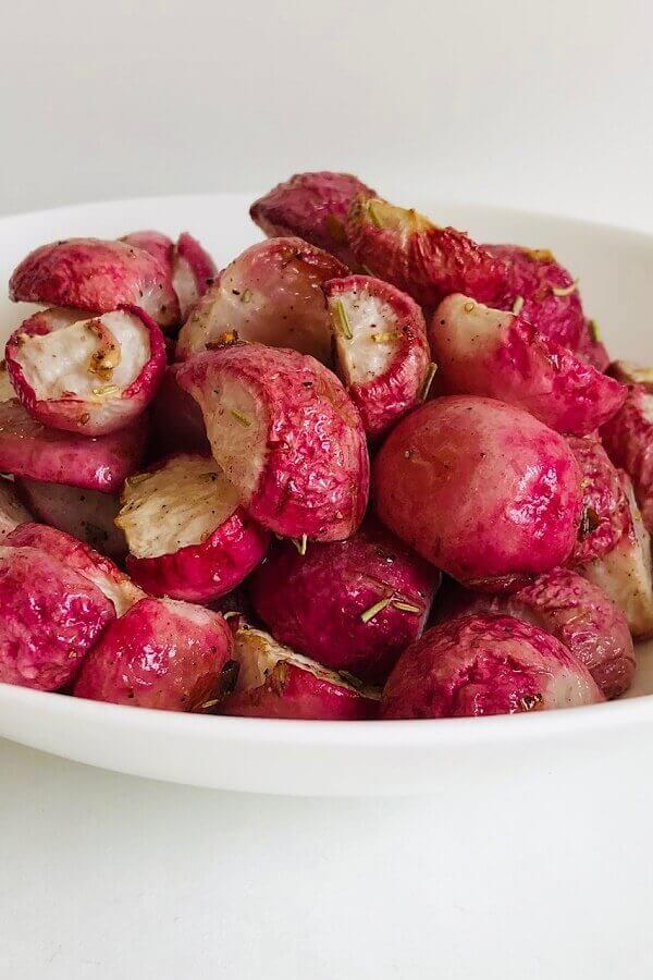 Baked radishes in a white bowl.