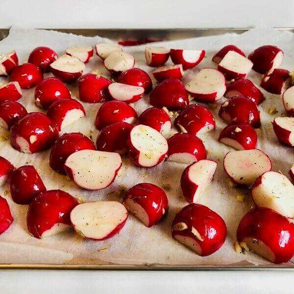 Raw radishes on a sheet pan.