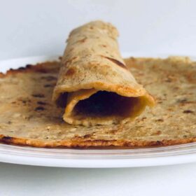 Two chickpea flour wraps on a plate.