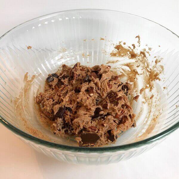 Cookie dough in a large glass mixing bowl.